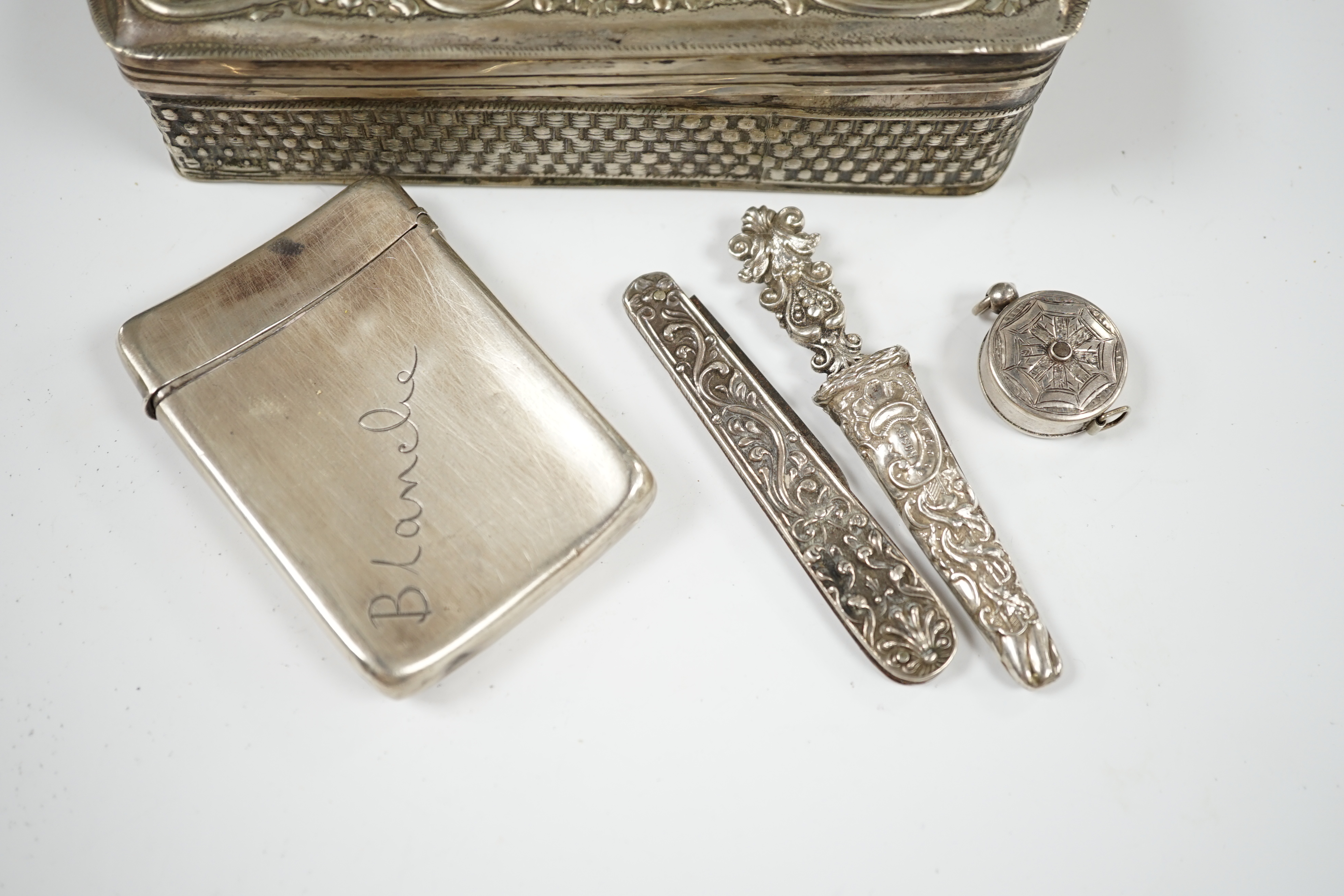 Sundry small silver including an Edwardian silver tea caddy, height 84mm, two silver condiments and four other items including a silver cased tape measure, together with a white metal trinket box. Condition - poor to fai